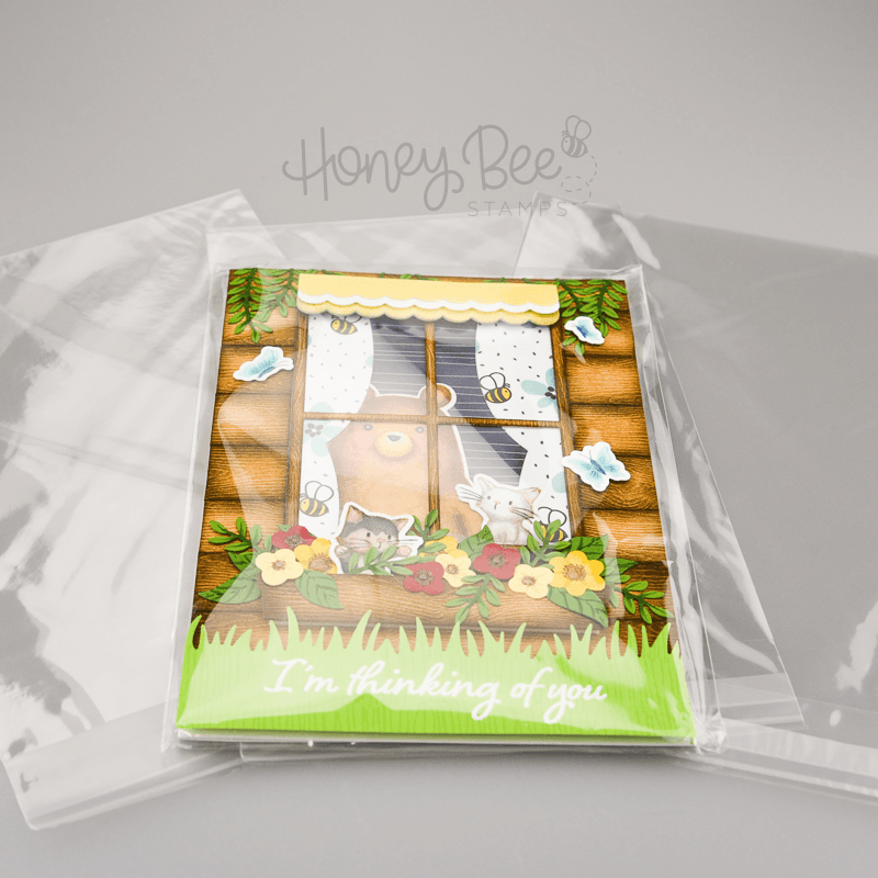 A handmade greeting card inside a Honey Bee Stamps crystal clear cello bag.