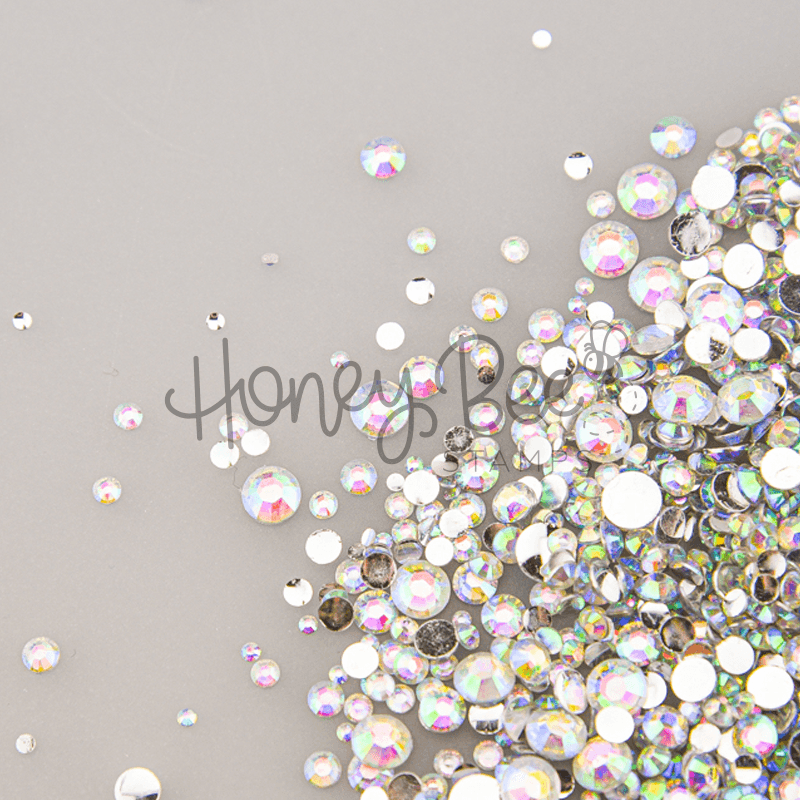 A mix of iridescent rainbow flatback crystal rhinestone gems by Honey Bee Stamps.