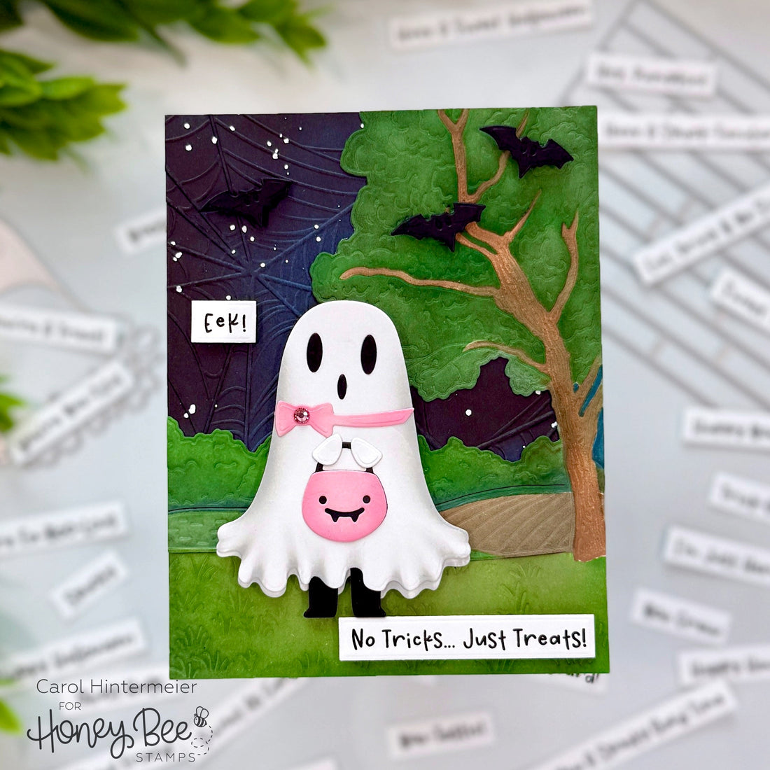Handmade Halloween card featuring a cute ghost with a treat bag, bats, and a golden tree.