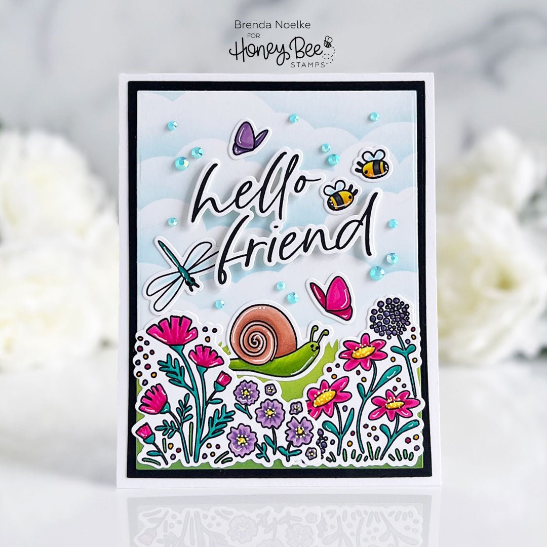 Handmade card with 'hello friend' text, a snail, bee, butterfly, and colorful spring flowers.