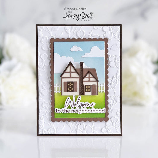 Handmade card featuring a 3D cottage scene and 'Welcome to the neighborhood' sentiment.