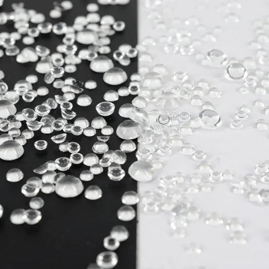 Honey Bee Stamps Dew Drops clear adhesive beads in various sizes on black and white backgrounds
