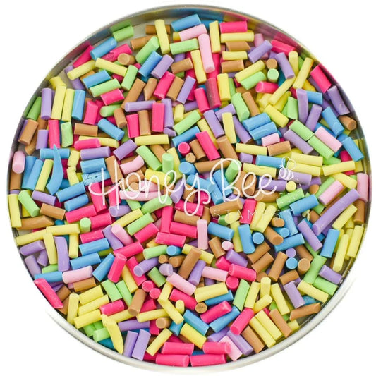 Multi-colored clay candy sprinkles pieces by Honey Bee Stamps in a round container